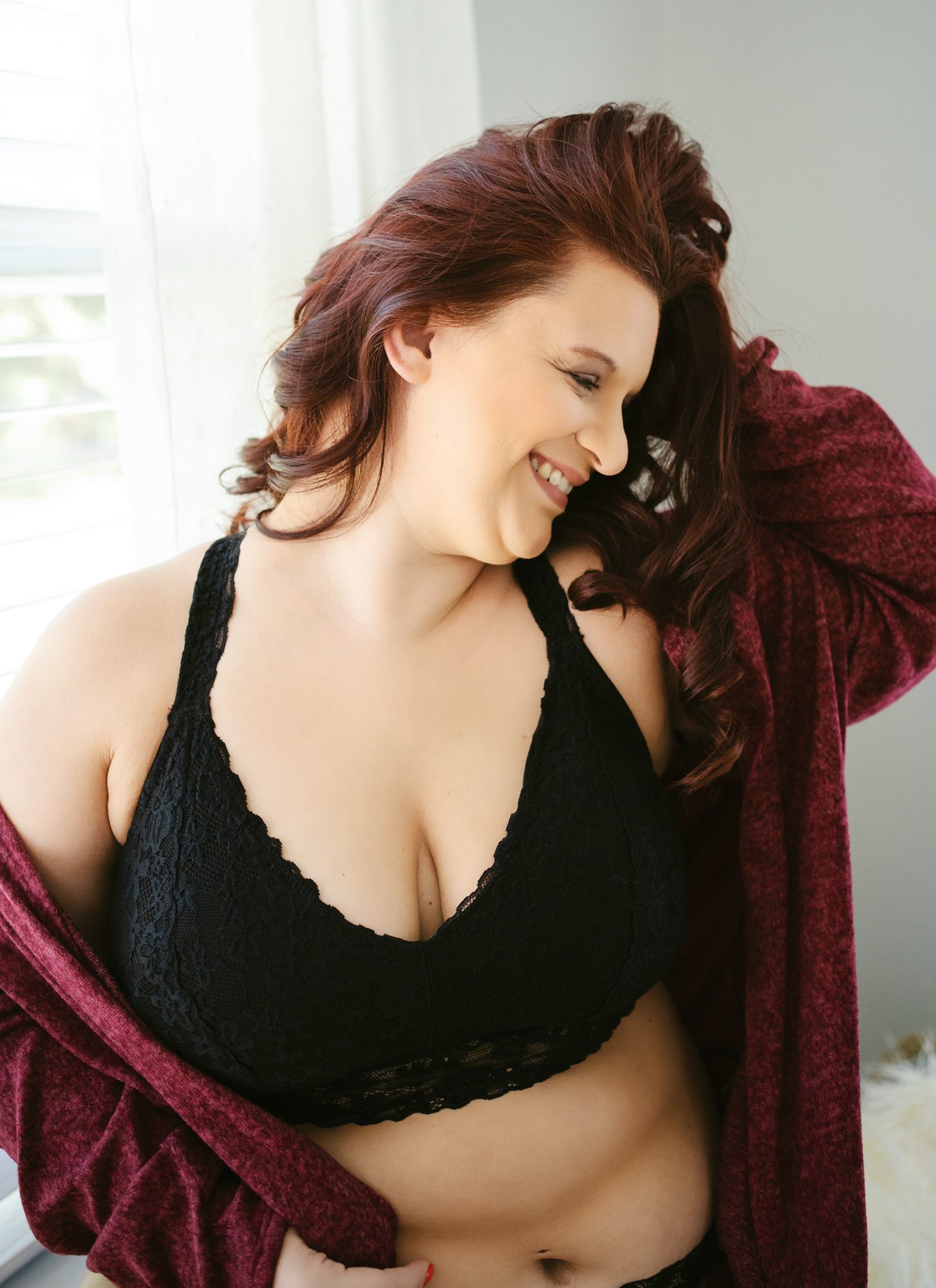 woman in black lingerie top smiling